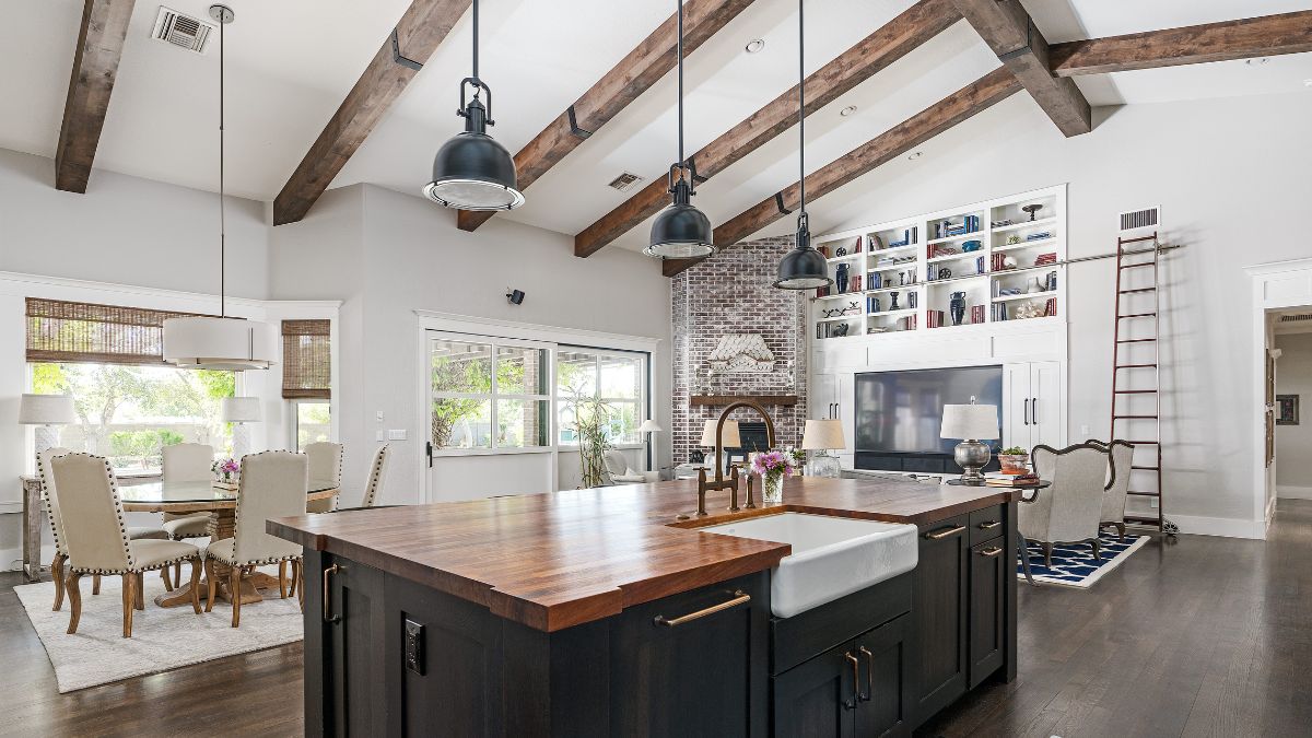 A spacious kitchen featuring a large island and wooden beams, ideal for post-holiday renovations in Los Angeles.