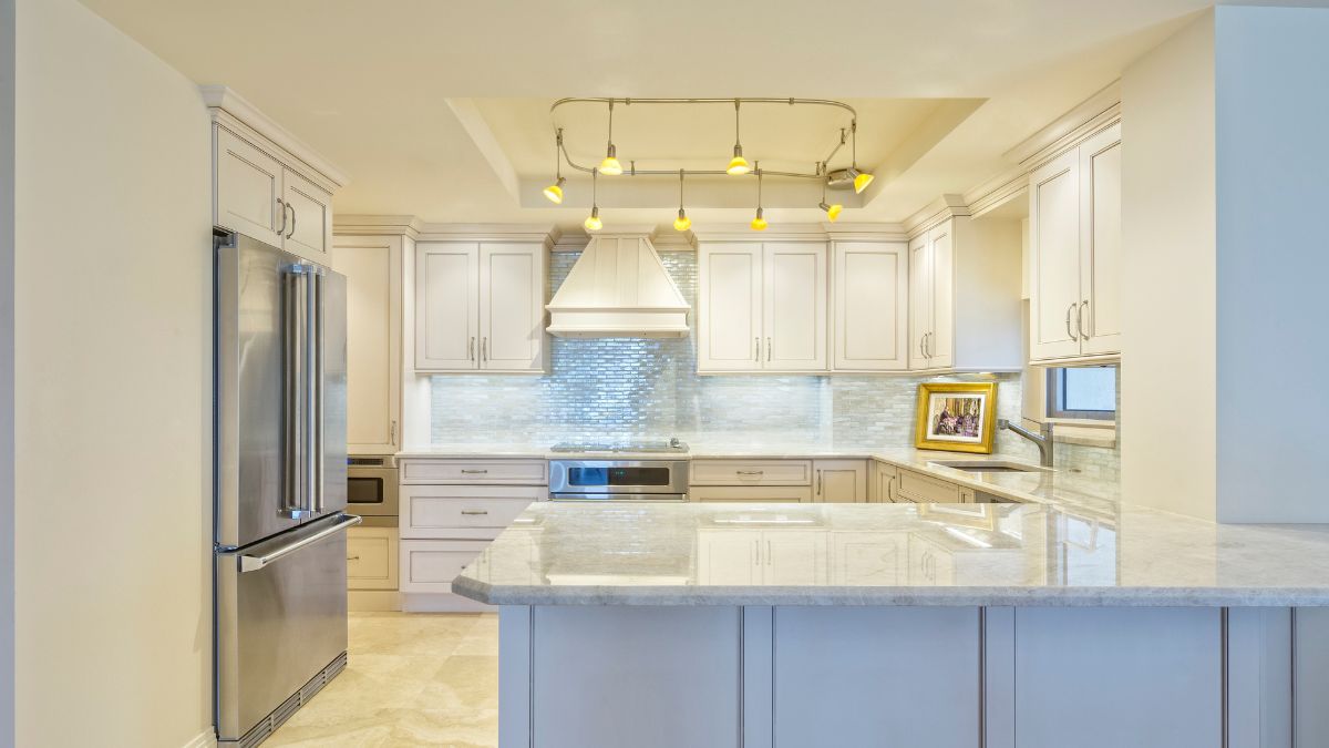 Stylish kitchen showcasing white cabinets and a stainless steel refrigerator, inspiring Los Angeles remodels for 2024.