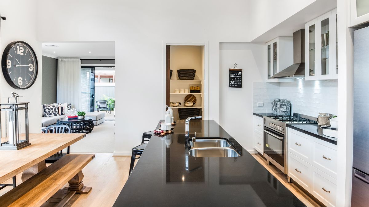 Stylish kitchen with a black countertop and table, perfect for Los Angeles homeowners considering renovations after the holidays.