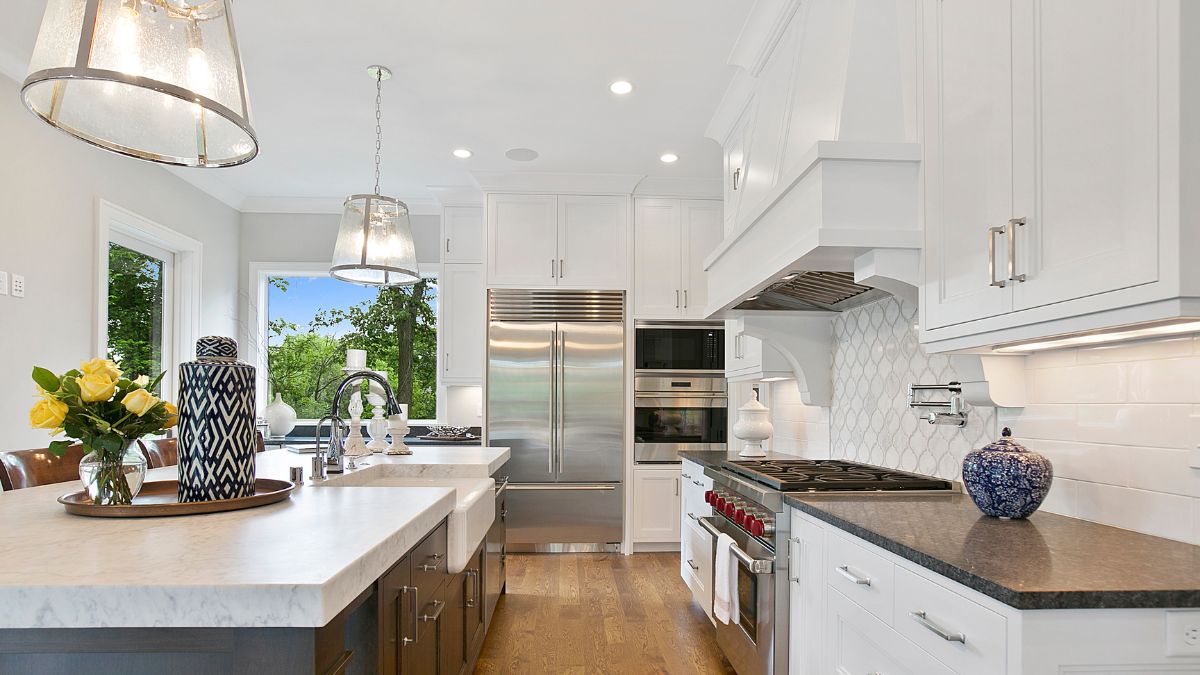 Bright kitchen with white cabinetry and a stylish black countertop, ideal for revitalizing your Los Angeles home after the holidays.