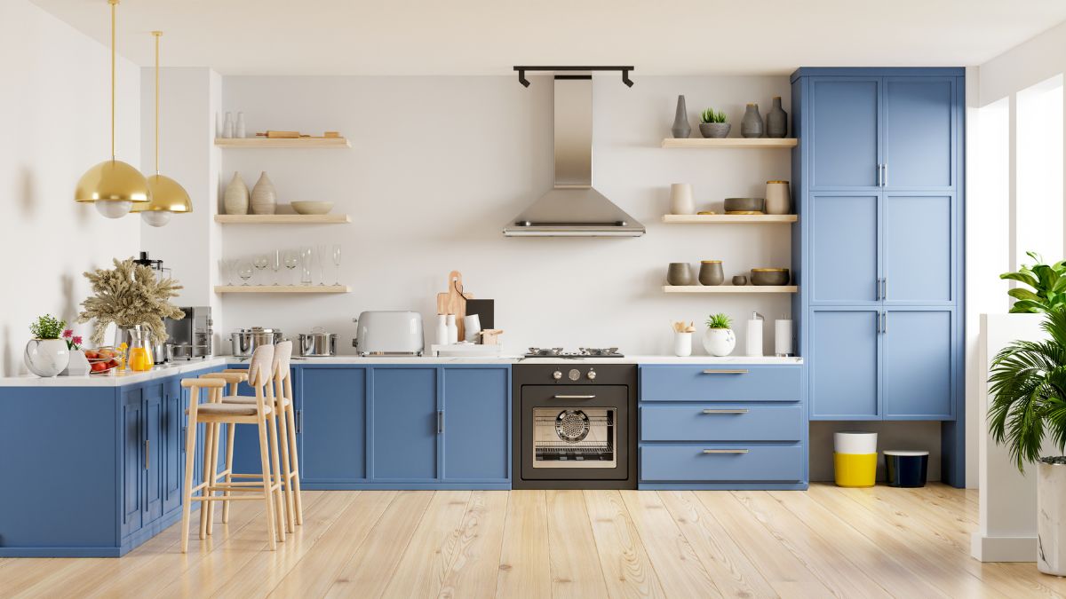 A kitchen featuring blue cabinets and wooden floors, ideal for a January remodel to enhance style and functionality.