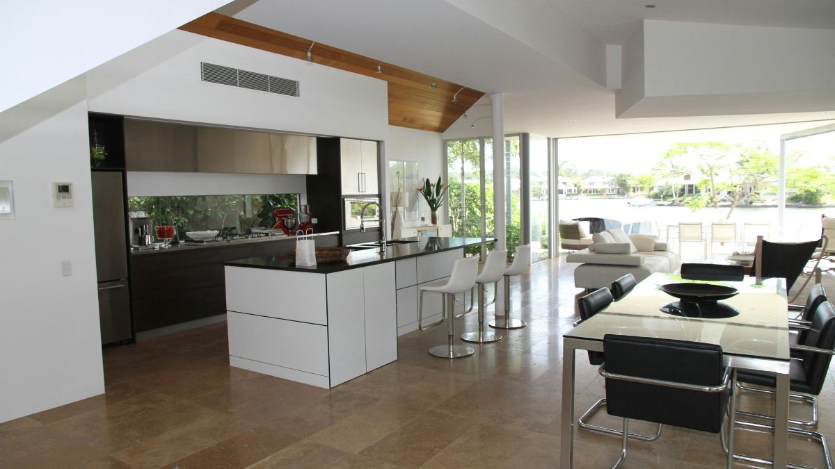 A cozy kitchen featuring a dining table surrounded by chairs, creating an inviting space for meals and gatherings.