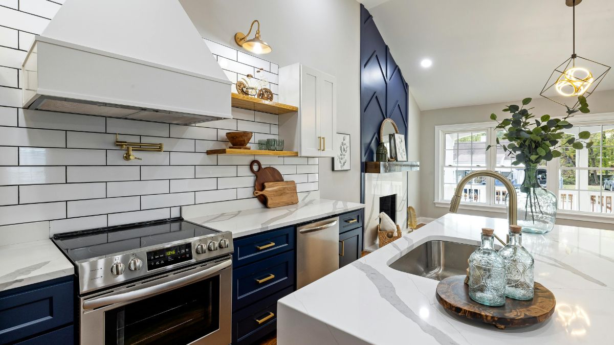 A modern kitchen featuring blue cabinets and elegant white countertops, creating a fresh and inviting atmosphere.