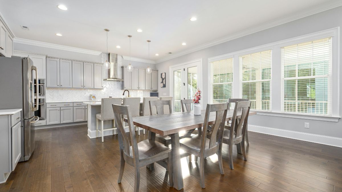 A cozy kitchen featuring a dining table surrounded by chairs, creating an inviting space for meals and gatherings.