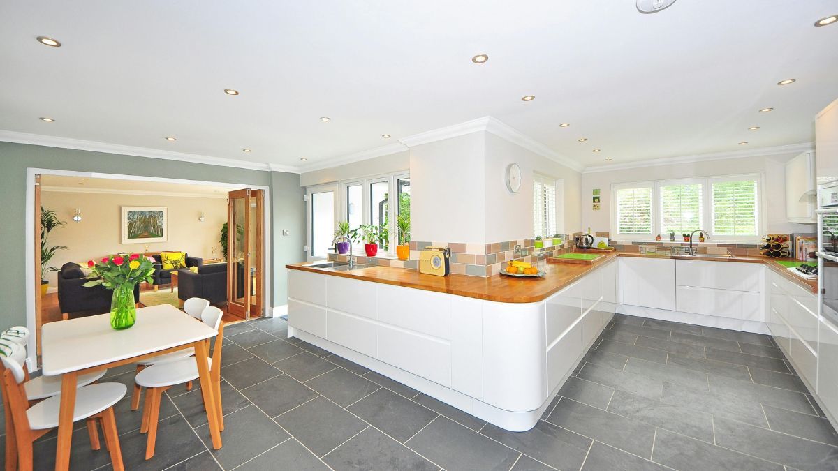 A cozy kitchen featuring a wooden table surrounded by chairs, creating an inviting dining space.