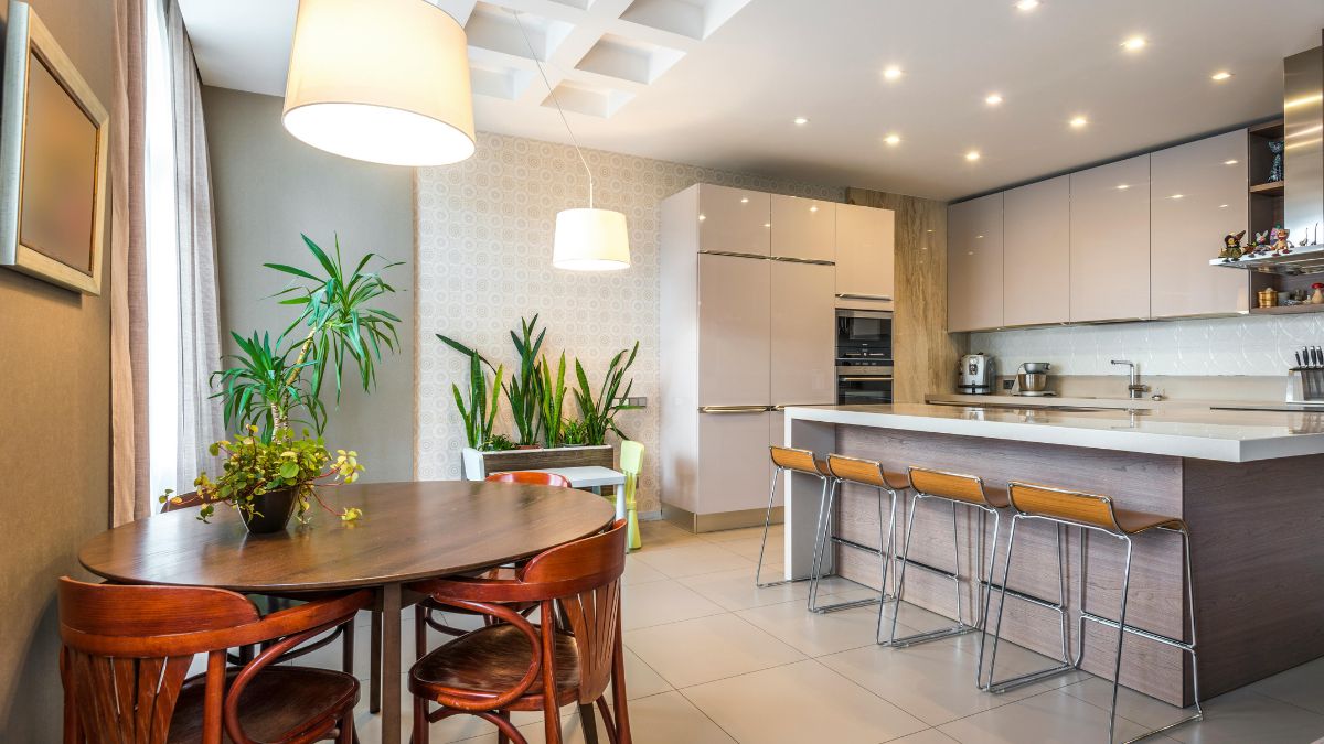 A contemporary kitchen featuring a dining table and chairs, showcasing a sleek and functional design.